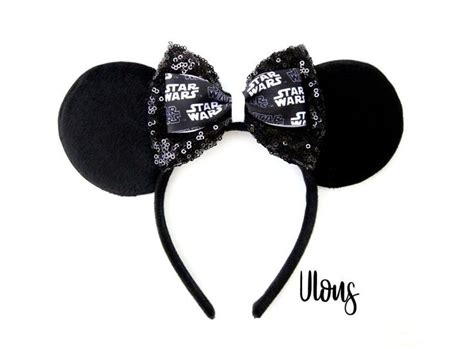 a star wars mouse ears headband is shown with the words, darth vader on it