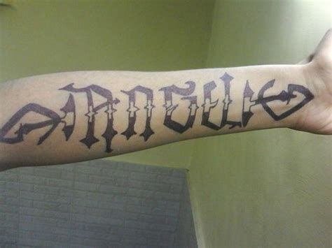 Interesting-designed angel word tattoo on forearm - Tattooimages.biz