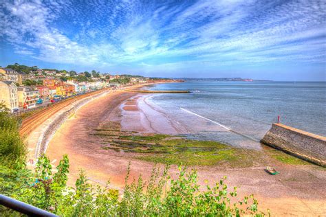 Dawlish Devon England with beach railway track and sea on blue sky ...