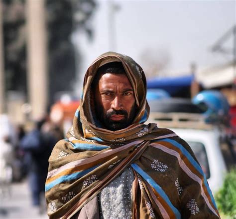 An Afghan man with Blanket around the head & hands made clothes. # ...