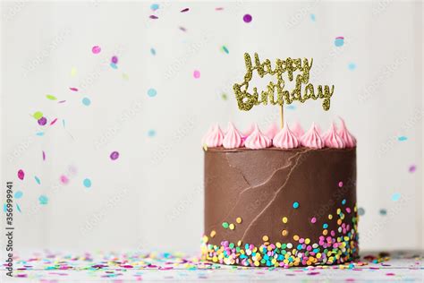 Chocolate birthday cake with happy birthday banner Stock Photo | Adobe ...