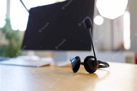 Premium Photo | Call center headset device and computer at the office desk