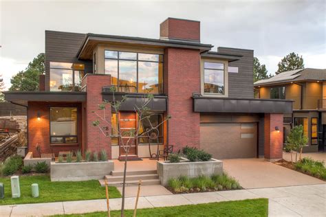 The very modern exterior of the home features red brick and dark brown ...