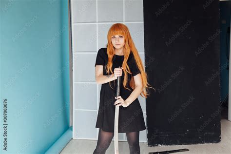 beautiful woman anime cosplayer with red hair with Japanese sword Stock ...