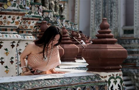 Tourist dressed in a traditional Thai costume visits Wat Arun temple in ...