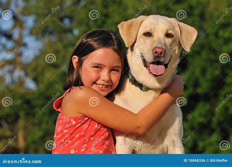 Happy child hugging a dog stock photo. Image of animal - 76868336