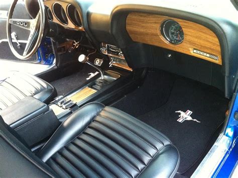 the interior of an old car with black leather seats and wood trim on ...