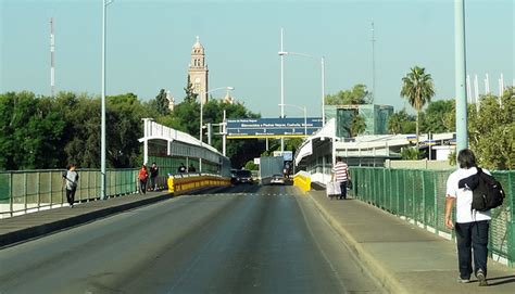 Vendors, sculptures and flags at the Mexican border - Quirky Travel Guy