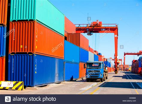 Cranes, trucks and cargo containers in shipping dock Stock Photo ...