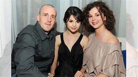 three people sitting next to each other in front of a white curtain ...