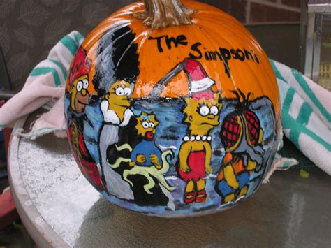 a painted pumpkin with the simpsons characters on it