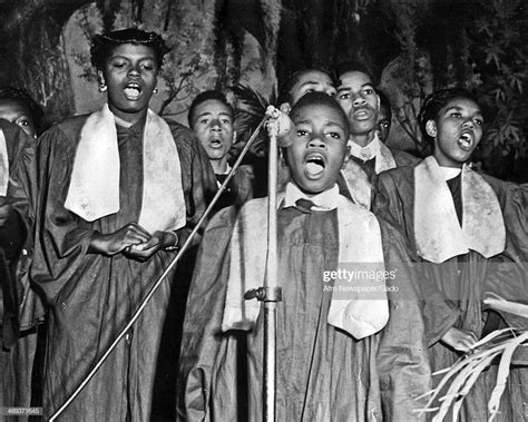 A church gospel choir with a boy at the microphone as the lead ...