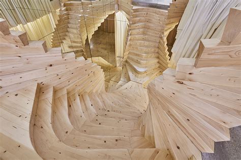 acme installs massive timber staircase with winding mirrors in its ...