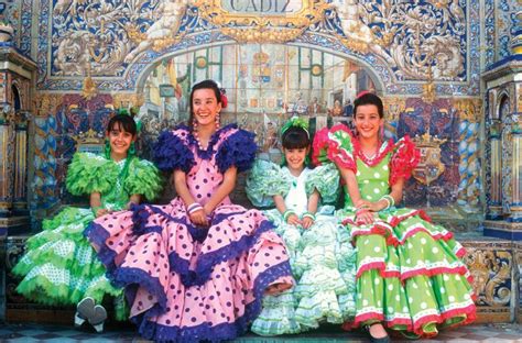 Spanish girls in traditional costume pose for a photograph in Sevilla ...