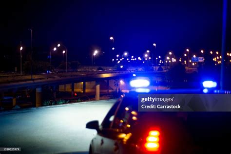 Police Car With Bright Sirens And The City In The Background High-Res ...