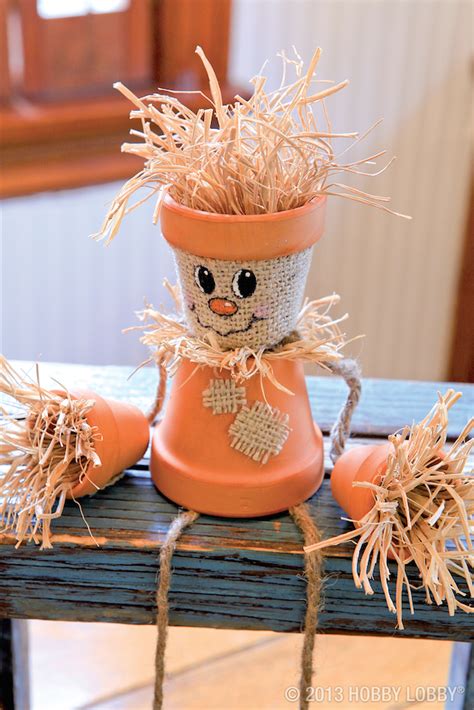 Create a friendly DIY fall project with terra-cotta pots, straw, and a ...