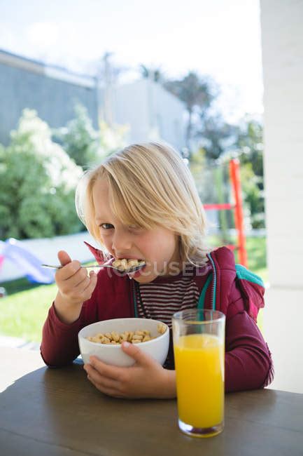 Boy having breakfast in porch at home — authentic, house - Stock Photo ...