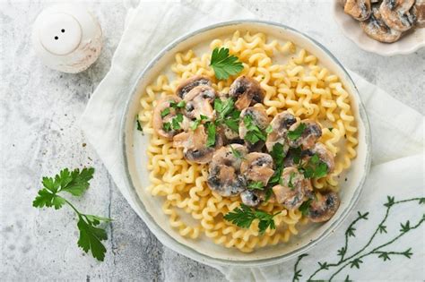 Premium Photo | Fusilli pasta with mushrooms cheese and garlic creamy ...