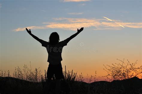 Triumphant Man at Sunset - Horizontal Stock Image - Image of nature ...