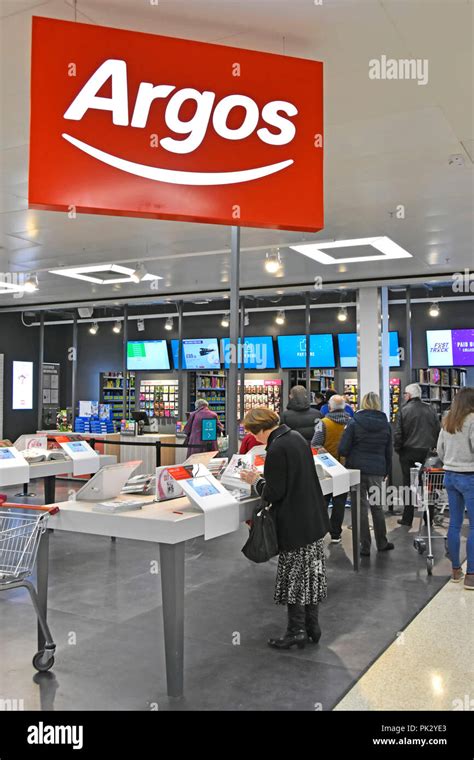 Shopping customers in new Argos catalogue shop inside a Sainsburys ...