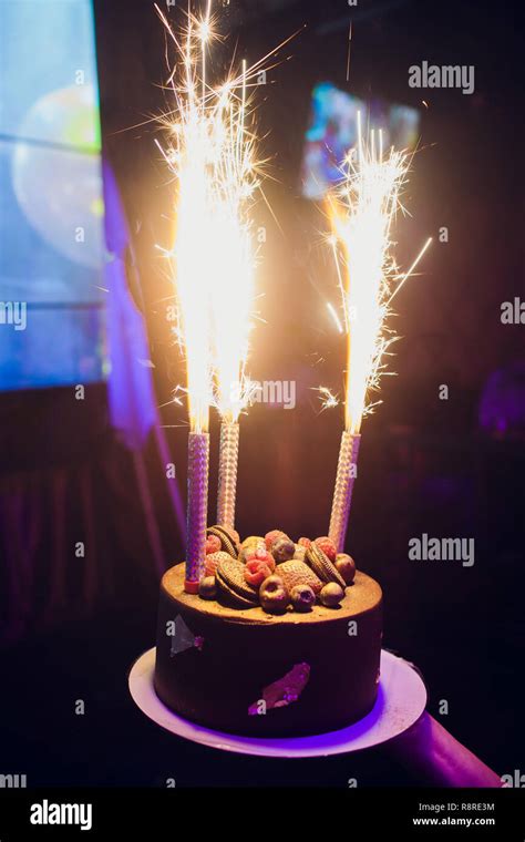 Birthday cake with fireworks on table Stock Photo - Alamy