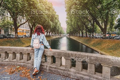 Happy Tourist Woman With Backpack Standing Near Konigsallee Water ...