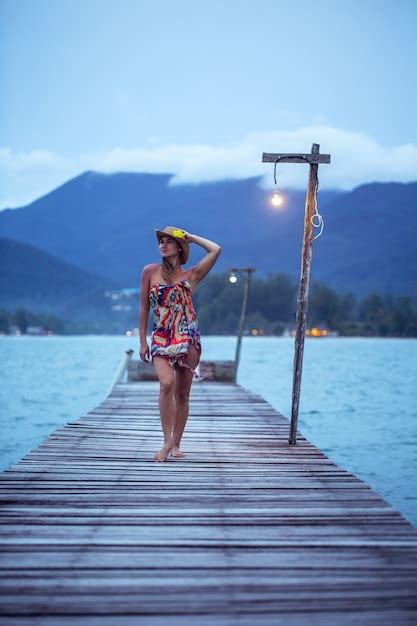 Free Photo | Beautiful girl in hat on the longest wooden pier in the ...