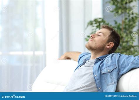 Man Resting on a Couch at Home Stock Photo - Image of hotel, breath ...