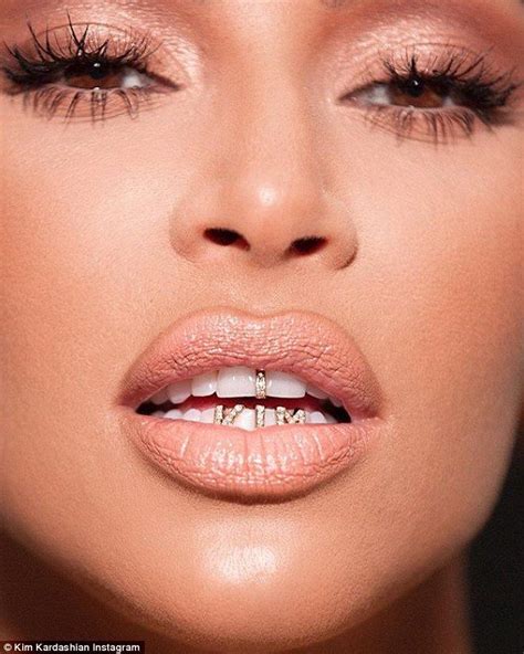 Kim Kardashian flaunts new name tag grills to promote KKW Beauty ...