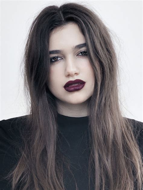 a woman with long brown hair and red lipstick