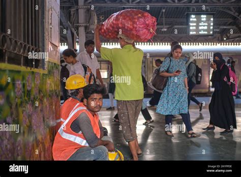 Construction workers sitting outside Byculla Station in Byculla, Mumbai ...