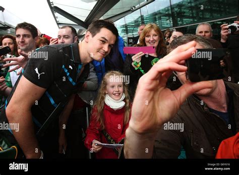 Jonathan Sexton poses with supporters as the Ireland team arrive at ...