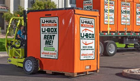 Couple loading a U-Box® container in their driveway