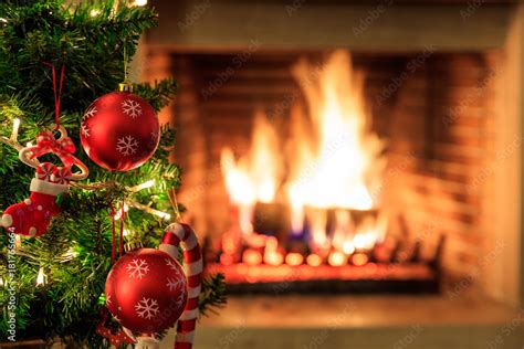 Christmas tree on burning fireplace background Stock-Foto | Adobe Stock