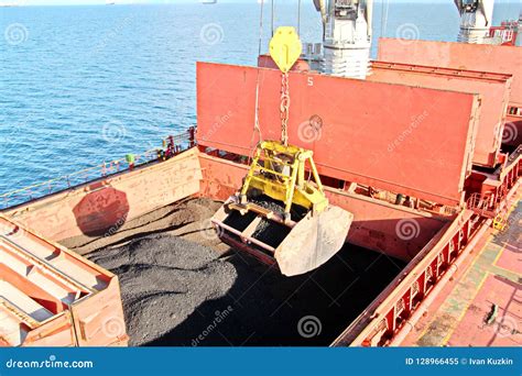 Loading Coal From Cargo Barges Onto A Bulk Carrier Using Ship Cranes ...