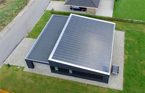 an aerial view of a house with a car parked in the driveway next to it