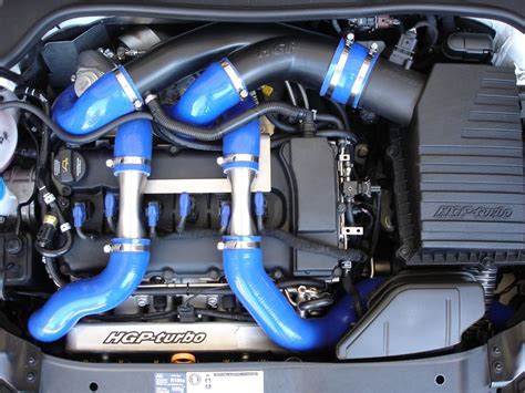 the engine compartment of a car with blue hoses