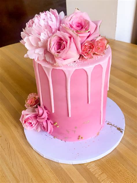 Pink Ombre Cake topped with fresh pink roses. Cake is decorated with ...