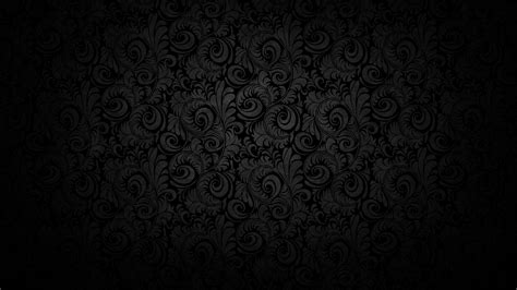 black wallpaper with swirls and scrolls on the bottom, as well as dark ...