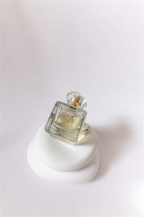 Vial of Perfume on White Fabric · Free Stock Photo