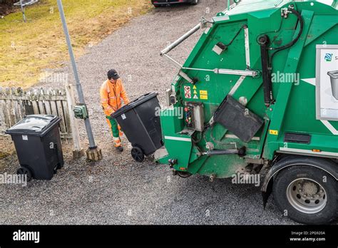 garbage truck driver empty trash in malmkoping sweden Stock Photo - Alamy