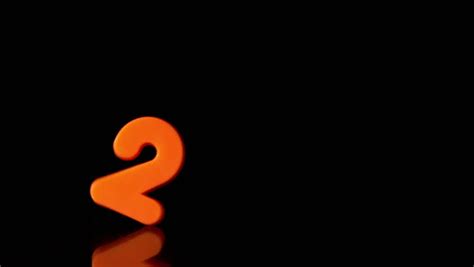 Orange Number Two Falling On Black Background In Slow Motion Stock ...