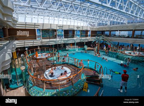 People enjoying the interior swimming pool on the cruise ship MSC ...