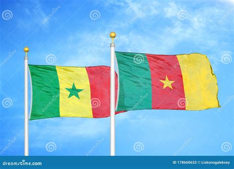 Senegal and Cameroon Two Flags on Flagpoles and Blue Cloudy Sky Stock ...