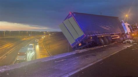 Lorry left hanging off bridge after M1 crash forces closure of major ...