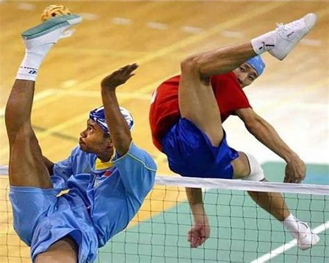 two men are playing tennis on a court with one reaching up to hit the ball