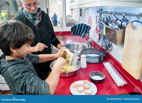 Happy Mom and Her Little Son Cooking Together in the Kitchen, Smiling ...