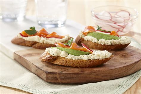 Crostini or toasted baguette with avocado, smoked salmon, sliced radish ...