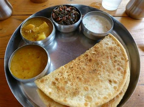 The thali style meal served with cauliflower stuffed parathas - Picture ...