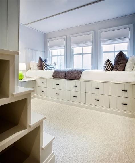 Cottage boy's bedroom features a wall of built-in beds fitted with ...